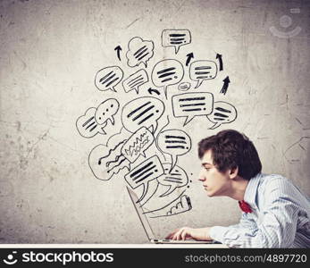 Businessman with ipad. Image of young businessman holding ipad against sketch background