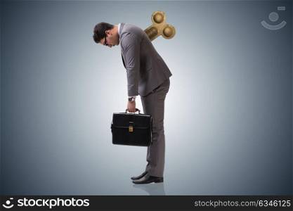 Businessman with key in hardworking concept