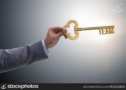 Businessman with key in teamwork concept