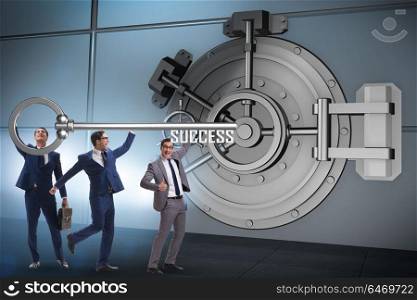 Businessman with key near bank vault door