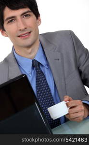 Businessman with laptop and coffee
