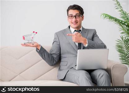 Businessman with laptop and shopping cart