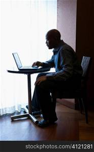 Businessman with Laptop at Cafe Table
