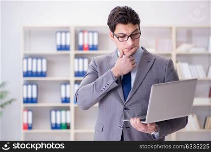 Businessman with laptop in the office