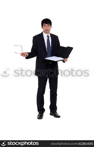 businessman with laptop looking puzzled