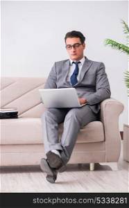 Businessman with laptop notebook sitting in sofa