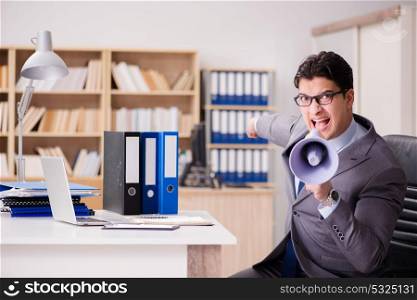 Businessman with loudspeaker in the office
