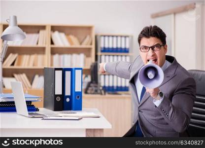 Businessman with loudspeaker in the office