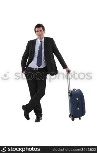 Businessman with luggage stood waiting