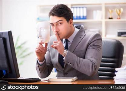 Businessman with mask in office hypocrisy concept