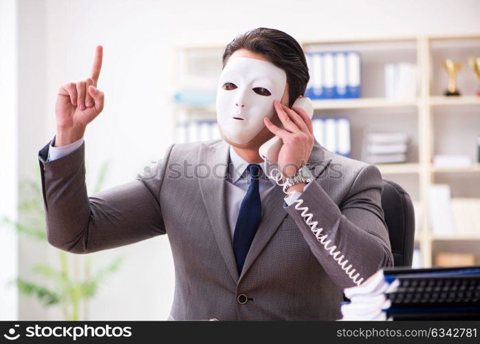 Businessman with mask in office hypocrisy concept