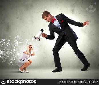 Businessman with megaphone. Angry businessman with megaphone shouting at colleague