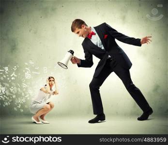 Businessman with megaphone. Angry businessman with megaphone shouting at colleague