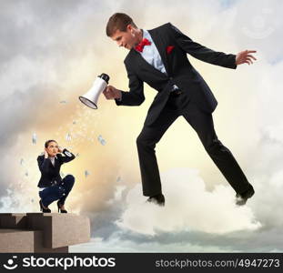 Businessman with megaphone. Angry businessman with megaphone shouting at colleague