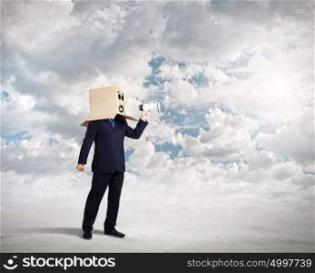 Businessman with megaphone. Businessman with box on head screaming in megaphone