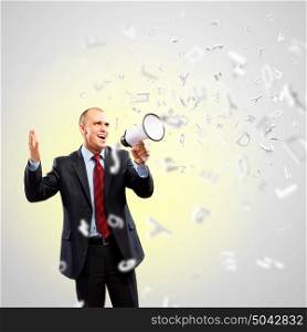 Businessman with megaphone. Image of angry businessman screaming in megaphone