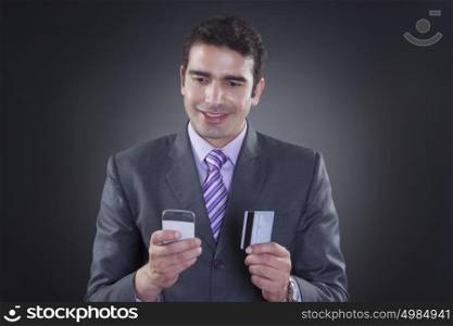 Businessman with mobile phone and credit card