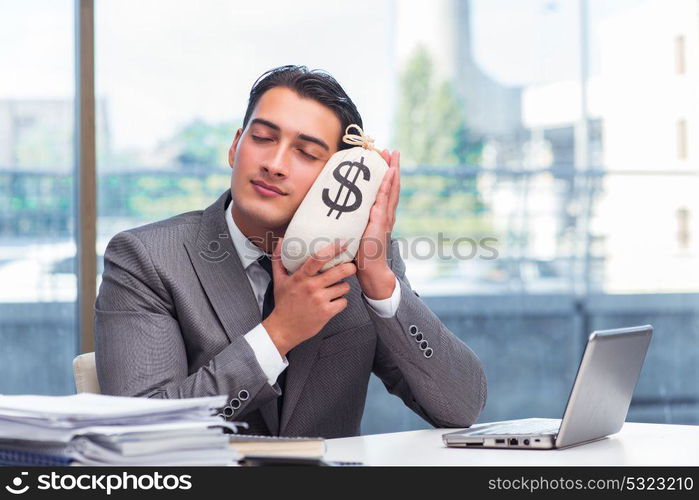 Businessman with money sack bag in office