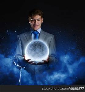 Businessman with moon. Young businessman holding moon planet in hand