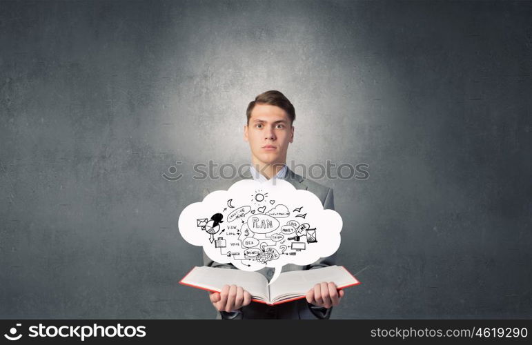 Businessman with opened book. Young businessman with opened book and plan sketches from pages