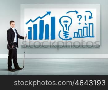 Businessman with paint brush and green energy symbols