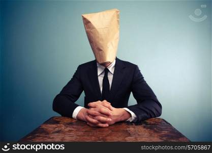 Businessman with paper bag over his head