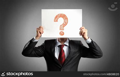 Businessman with paper banner. Businessman holding paper sheet with question mark in front of his face