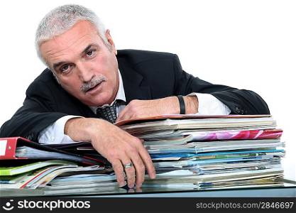 businessman with pile of documents