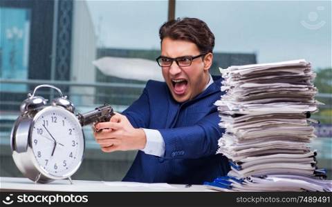 Businessman with pile stack of paper paperwork and an alarm clock working in the office. Businessman with pile stack of paper paperwork and an alarm cloc