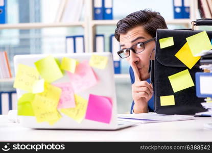 Businessman with reminder notes in multitasking concept