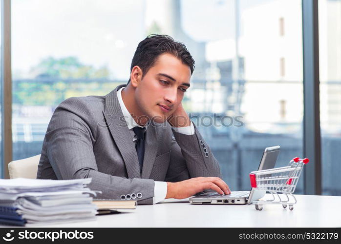 Businessman with shopping cart in office