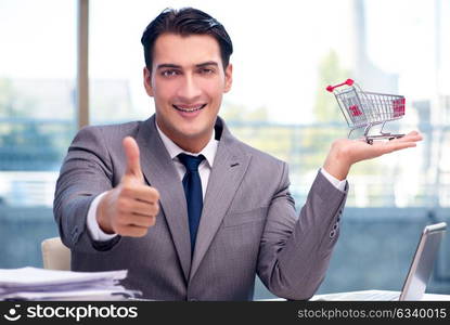 Businessman with shopping cart in office