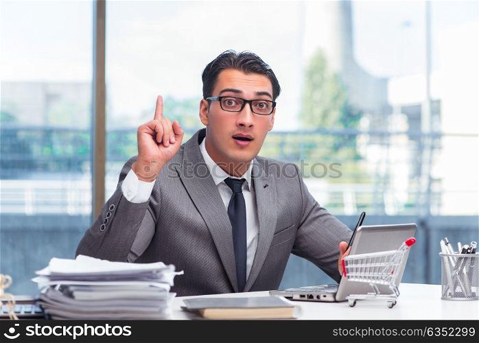 Businessman with shopping cart in office