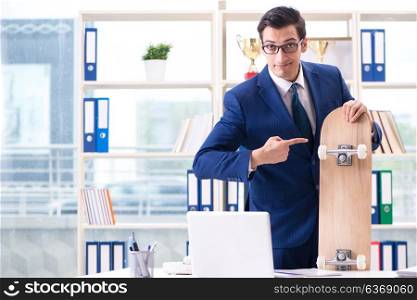 Businessman with skateboard in office