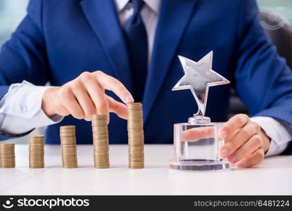 Businessman with stacks of coins in the office