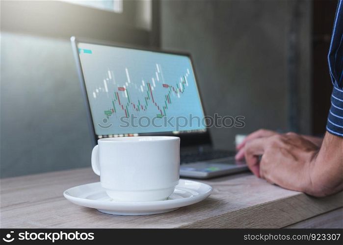 Businessman with statistic graph of stock market financial indices analysis on laptop screen, finance data and technology concept