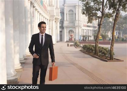 Businessman with suitcase and mobile phone , INDIA , DELHI