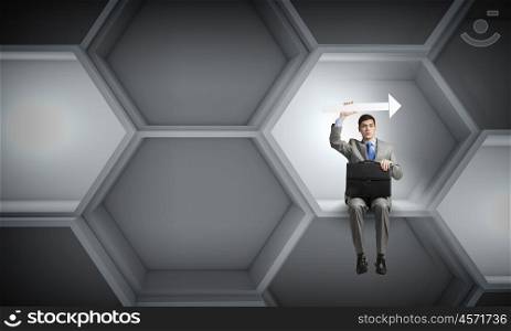 Businessman with suitcase. Young handsome businessman with briefcase and arrow in hands