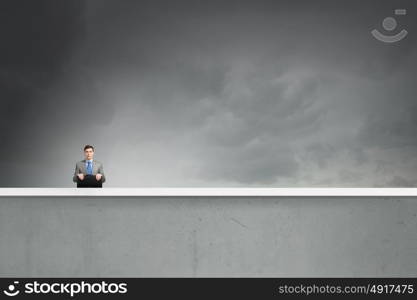 Businessman with suitcase. Young handsome businessman with briefcase in hands