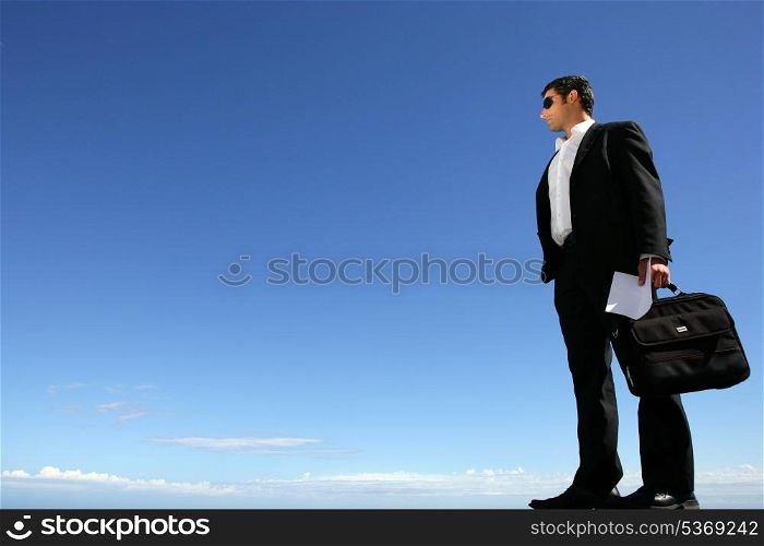 Businessman with sunglasses and briefcase