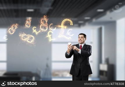 Businessman with tablet device in hands. Adult businessman in office dark interior using tablet pc