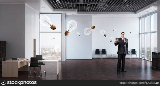 Businessman with tablet in hand. Adult businessman in modern office interior using tablet pc