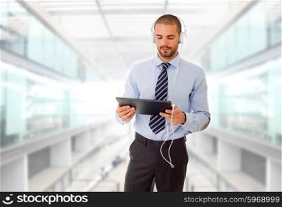 businessman with tablet pc and headphones, at the office