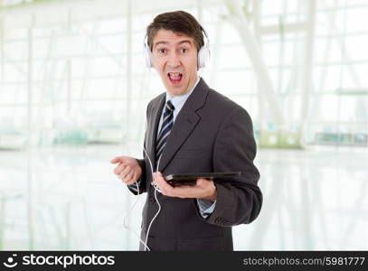 businessman with tablet pc and headphones, at the office