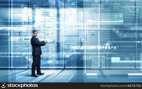 Businessman with tablet pc. Businessman on digital futuristic background using his tablet pc