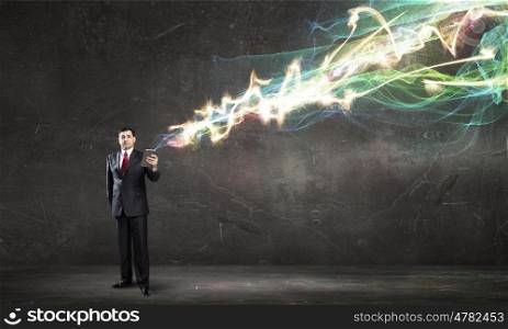 Businessman with tablet pc. Businessman using his tablet pc and glowing light out of screen