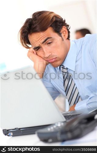 Businessman with tired look at work