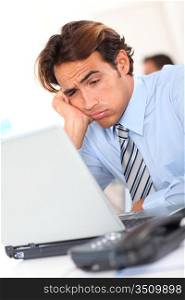 Businessman with tired look at work