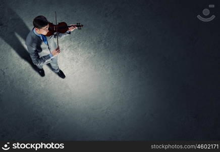 Businessman with violin. Top view of young businessman playing violin