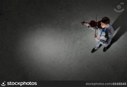 Businessman with violin. Top view of young businessman playing violin